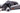 Pet2go Image Perro negro grande acostado en cama Deluxe Pet2Go gris oscuro con una pata sobre el borde